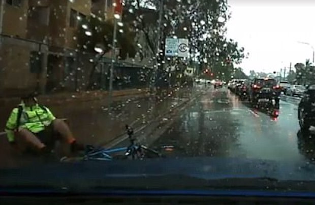 cyclist slides into oncoming traffic