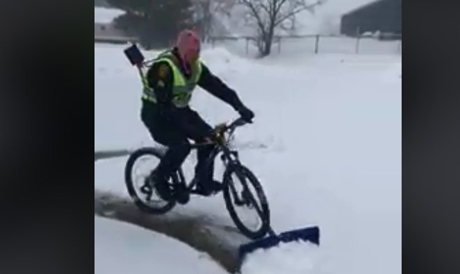 police officer bike shovel snow