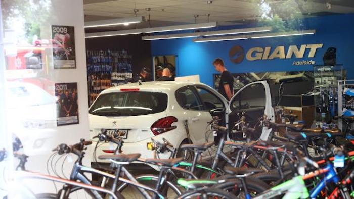 car ploughs into giant bike shop adelaide