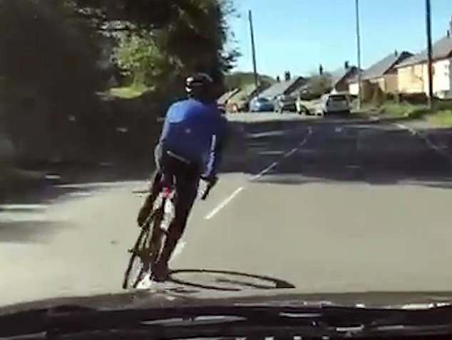 cyclist swerves in front of car video