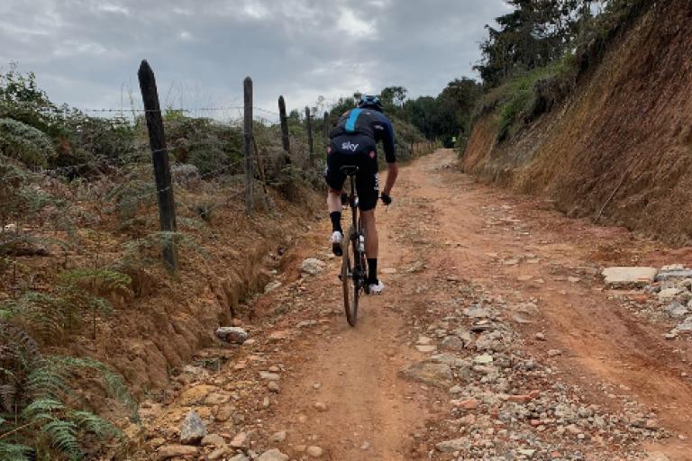 chris froome on time trial bike on gravel roads